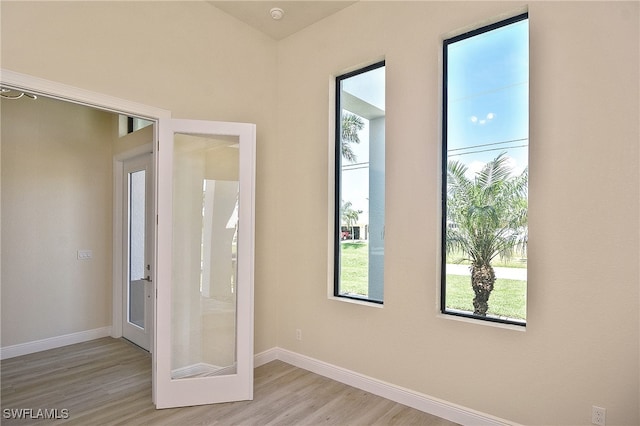 doorway to outside featuring wood finished floors and baseboards