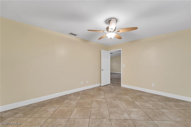 empty room featuring ceiling fan, baseboards, and light tile patterned floors