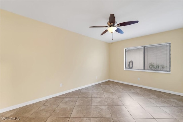 unfurnished room with ceiling fan, light tile patterned floors, and baseboards