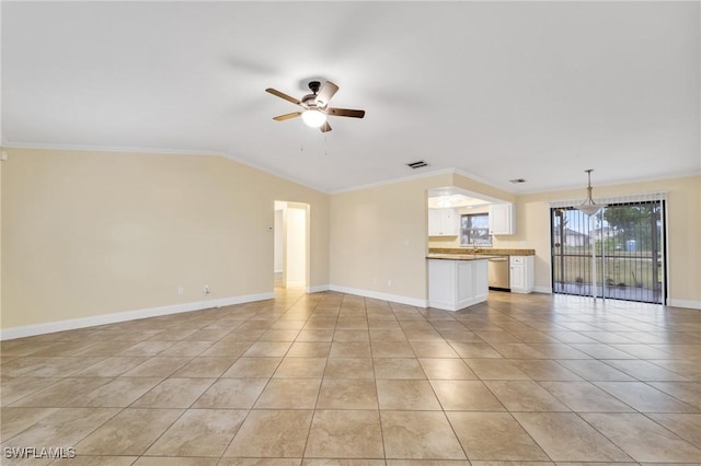 unfurnished living room with ceiling fan, light tile patterned flooring, ornamental molding, baseboards, and lofted ceiling
