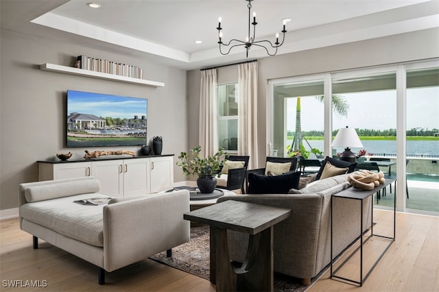 9102 Wisteria Way, Naples, FL 34114 - living area with light wood-type flooring, a chandelier, recessed lighting, a raised ceiling, and baseboards