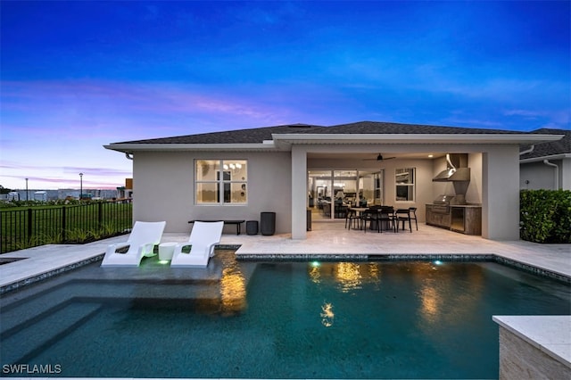 9102 Wisteria Way, Naples, FL 34114 - rear view of house with exterior kitchen, stucco siding, ceiling fan, a patio area, and outdoor dining area