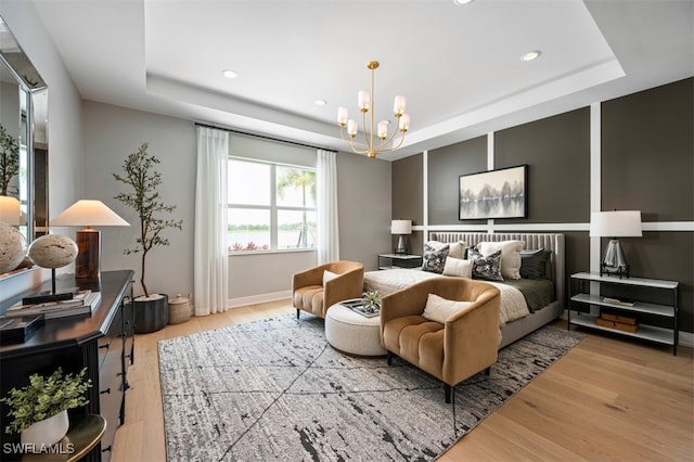 9102 Wisteria Way, Naples, FL 34114 - bedroom with a tray ceiling, wood finished floors, a chandelier, recessed lighting, and baseboards