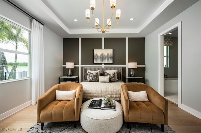 9102 Wisteria Way, Naples, FL 34114 - bedroom featuring wood finished floors, a chandelier, multiple windows, a tray ceiling, and recessed lighting