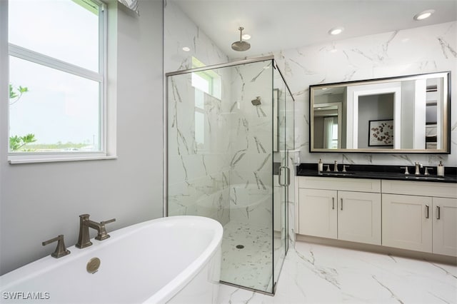 9102 Wisteria Way, Naples, FL 34114 - full bath featuring marble tiled floors, a marble finish shower, double vanity, a freestanding bath, and recessed lighting