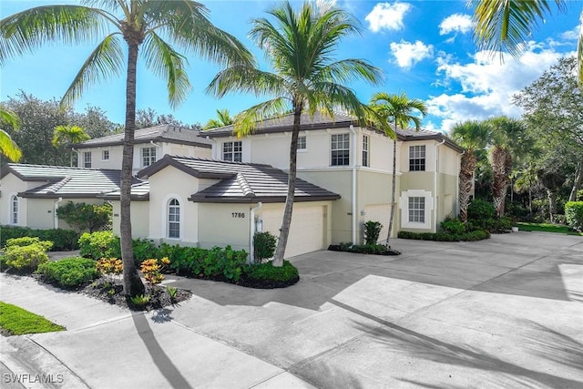 1786 Tarpon Bay Dr S Unit 102, Naples, FL 34119 - view of front of home with driveway, stucco siding, and a tiled roof