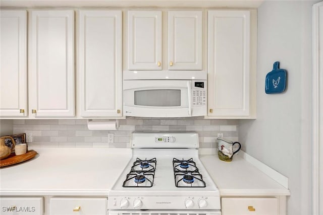 1786 Tarpon Bay Dr S Unit 102, Naples, FL 34119 - kitchen featuring white appliances, white cabinets, light countertops, and backsplash