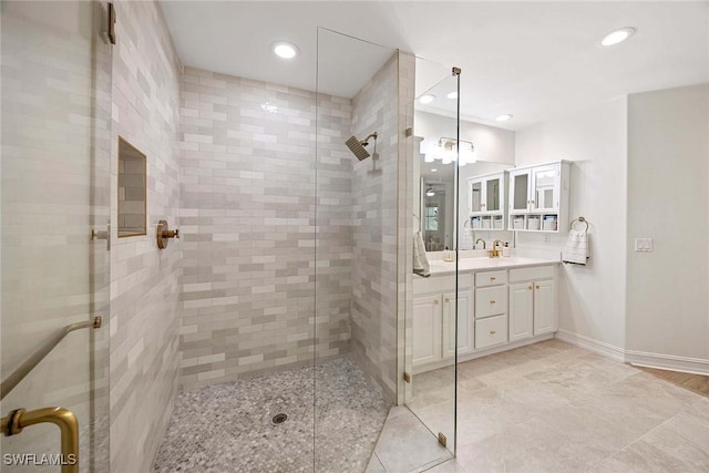 1786 Tarpon Bay Dr S Unit 102, Naples, FL 34119 - full bath featuring a stall shower, vanity, recessed lighting, and baseboards