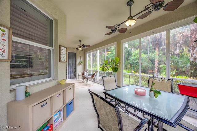 1786 Tarpon Bay Dr S Unit 102, Naples, FL 34119 - sunroom featuring ceiling fan, outdoor dining space, and a textured wall