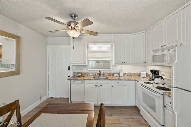 5900 Bonita Beach Rd # 1405, Bonita Springs, FL 34134 - kitchen with white appliances, a sink, white cabinets, a textured ceiling, and ceiling fan