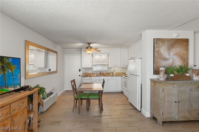 5900 Bonita Beach Rd # 1405, Bonita Springs, FL 34134 - kitchen with white appliances, ceiling fan, a sink, white cabinetry, and a textured ceiling