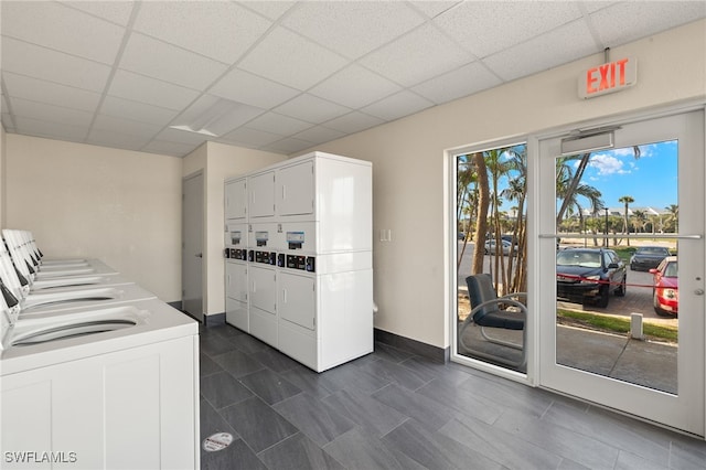 5900 Bonita Beach Rd # 1405, Bonita Springs, FL 34134 - community laundry with stacked washer / dryer, baseboards, and dark tile patterned floors