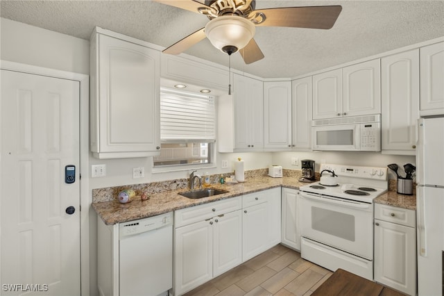 5900 Bonita Beach Rd # 1405, Bonita Springs, FL 34134 - kitchen with white appliances, a sink, white cabinetry, light stone countertops, and a textured ceiling