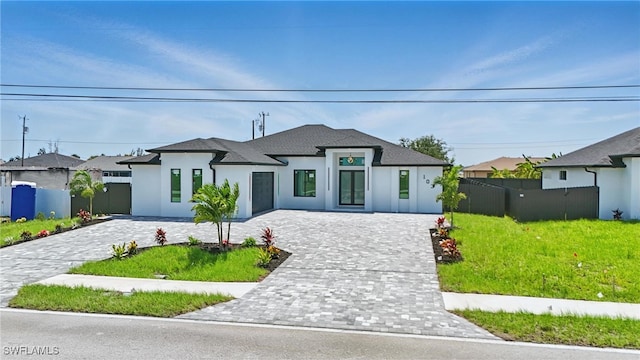 103 Chiquita Blvd N, Cape Coral, FL 33993 - french country style house with stucco siding, decorative driveway, and a shingled roof