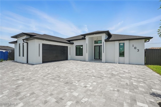 103 Chiquita Blvd N, Cape Coral, FL 33993 - view of front facade featuring stucco siding, a garage, and decorative driveway