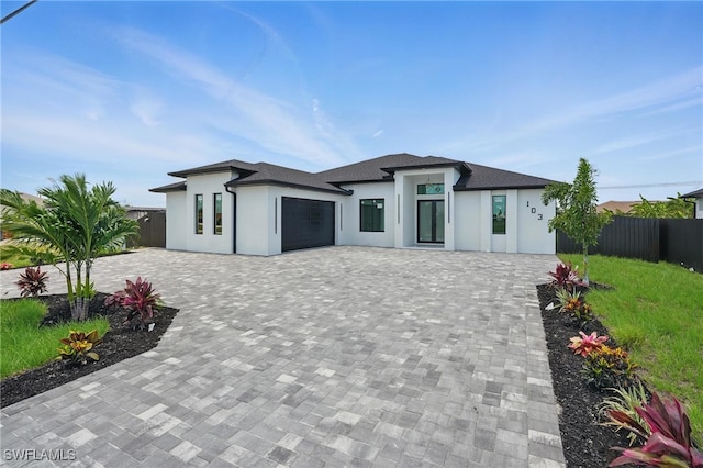 103 Chiquita Blvd N, Cape Coral, FL 33993 - view of front of home with decorative driveway, stucco siding, and a garage