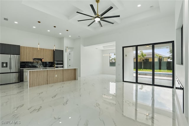 103 Chiquita Blvd N, Cape Coral, FL 33993 - kitchen with stainless steel fridge, open floor plan, recessed lighting, modern cabinets, and a center island