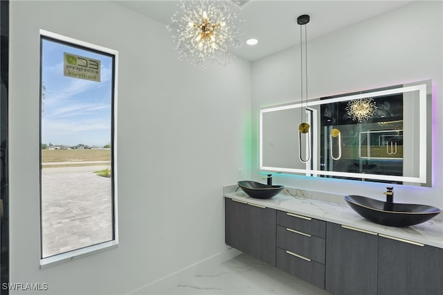 103 Chiquita Blvd N, Cape Coral, FL 33993 - full bath with marble look tile flooring, double vanity, baseboards, and a chandelier