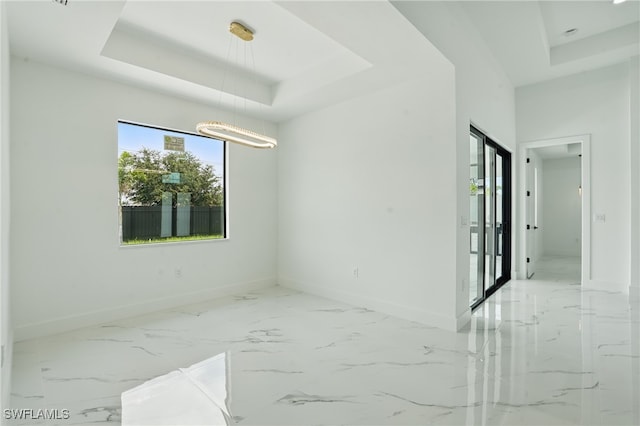 103 Chiquita Blvd N, Cape Coral, FL 33993 - unfurnished room featuring a tray ceiling, baseboards, and marble finish flooring