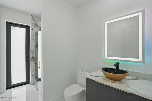 103 Chiquita Blvd N, Cape Coral, FL 33993 - bathroom featuring a marble finish shower, vanity, marble finish flooring, toilet, and baseboards