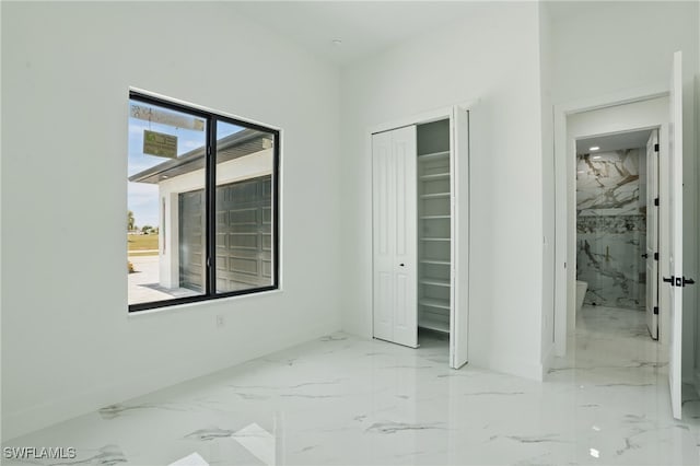 103 Chiquita Blvd N, Cape Coral, FL 33993 - unfurnished bedroom with marble finish floors, a closet, and baseboards
