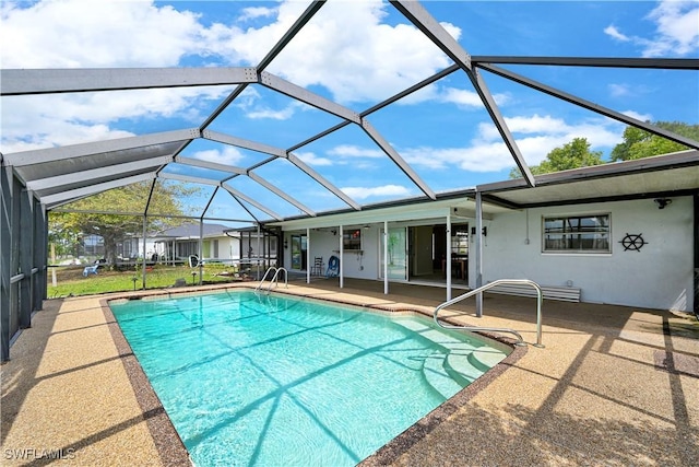 outdoor pool featuring a patio and glass enclosure