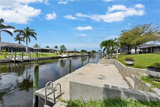 dock area featuring a water view, a residential view, and a lawn
