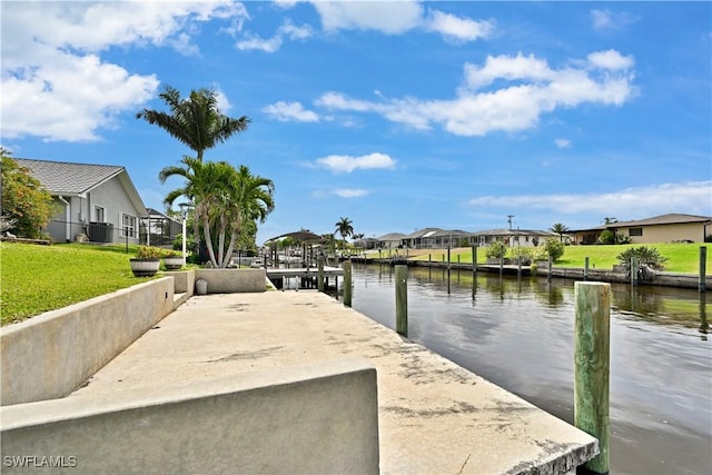 dock with a residential view, cooling unit, a water view, and a yard