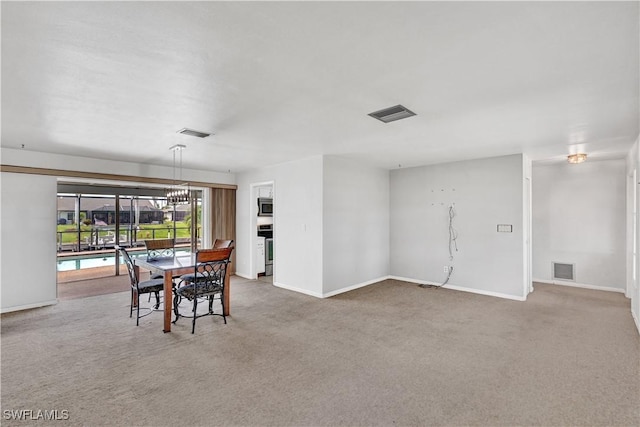 dining area featuring carpet and baseboards