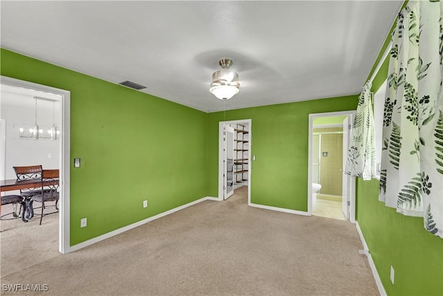 1414 Shelby Pkwy, Cape Coral, FL 33904 - unfurnished bedroom featuring carpet, baseboards, ensuite bathroom, and a chandelier