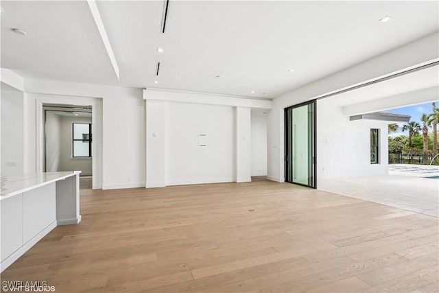 unfurnished living room with light wood finished floors and recessed lighting