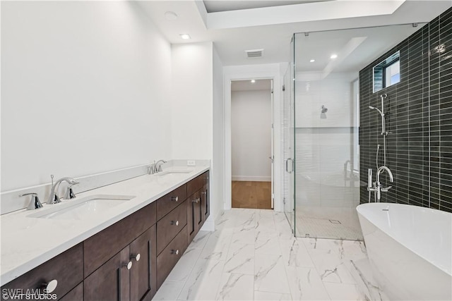 full bathroom with a stall shower, recessed lighting, a soaking tub, marble look tiles, and double vanity