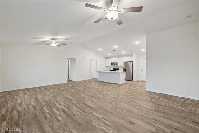 unfurnished living room with a ceiling fan, light wood finished floors, lofted ceiling, baseboards, and recessed lighting