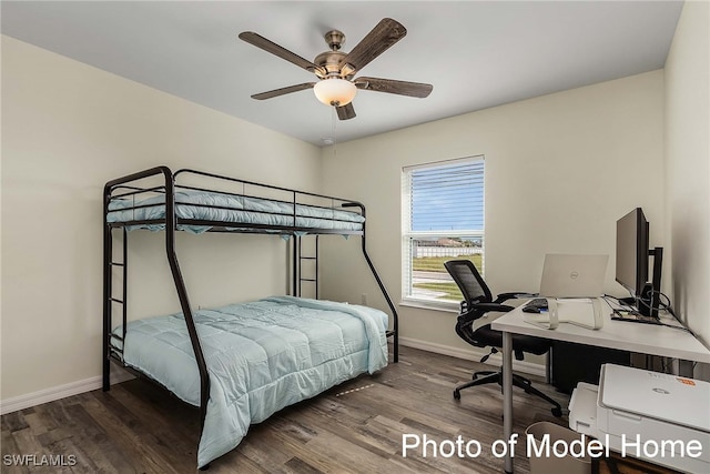 bedroom with baseboards, wood finished floors, an office area, and ceiling fan