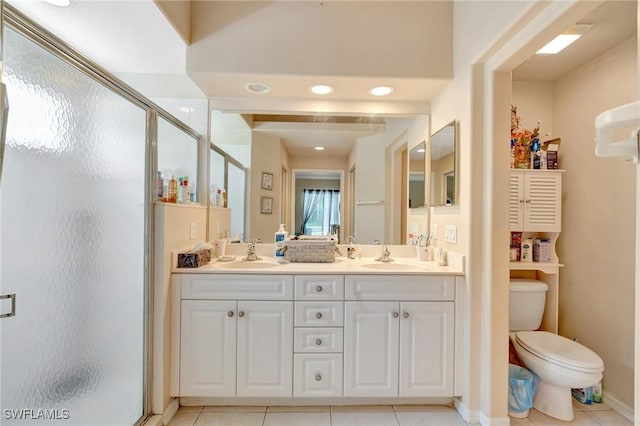 8012 Sivon Way Unit 902, Naples, FL 34119 - bathroom featuring a shower stall, tile patterned floors, double vanity, and toilet