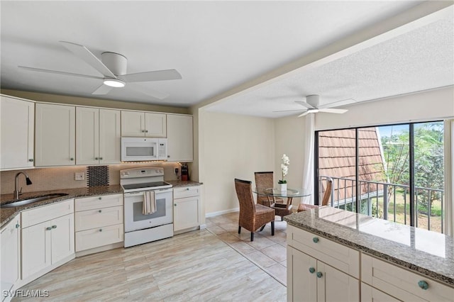 430 Meadowlark Ln Unit 430B, Naples, FL 34105 - kitchen with white appliances, a sink, a ceiling fan, stone countertops, and baseboards