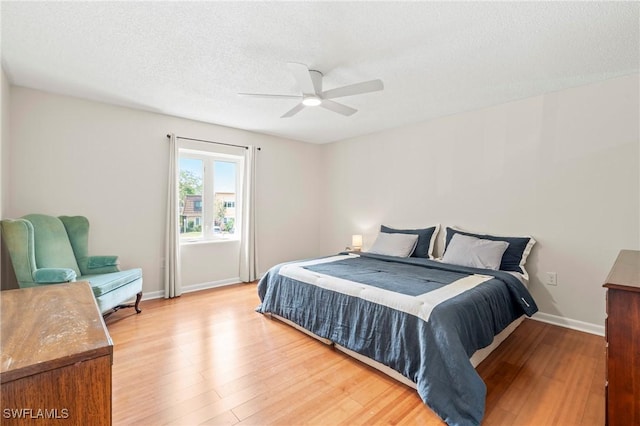 430 Meadowlark Ln Unit 430B, Naples, FL 34105 - bedroom featuring light wood finished floors, baseboards, a ceiling fan, and a textured ceiling