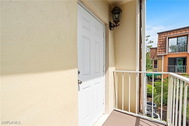 430 Meadowlark Ln Unit 430B, Naples, FL 34105 - view of exterior entry with stucco siding and a balcony