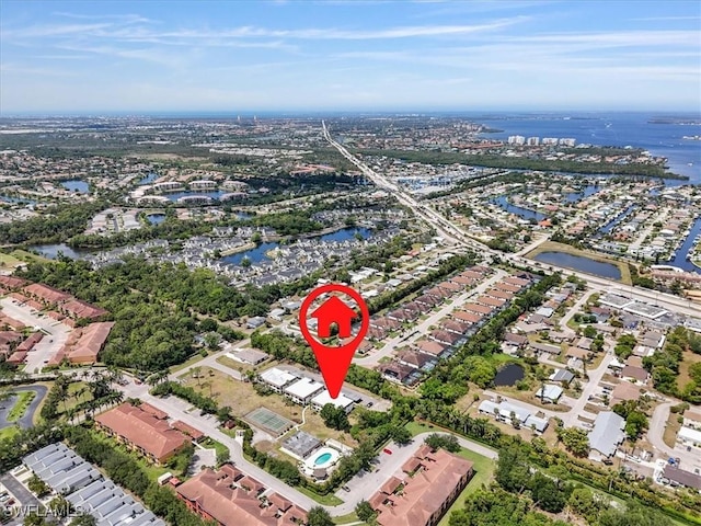 aerial overview of property's location with a nearby body of water and nearby suburban area