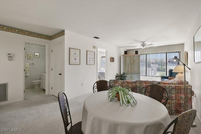 carpeted dining area featuring a ceiling fan