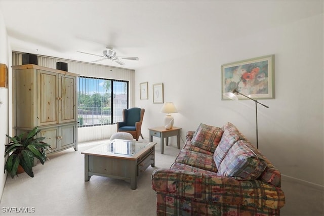 living area featuring light carpet and a ceiling fan