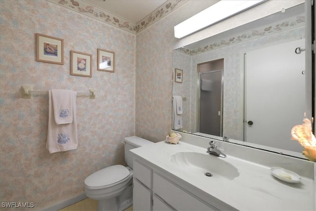 bathroom featuring wallpapered walls, vanity, toilet, and a shower
