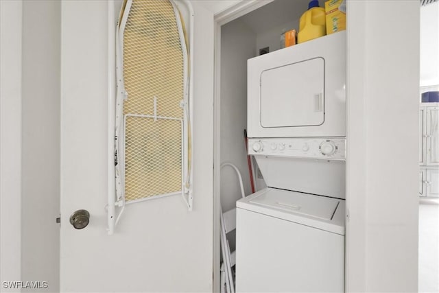 laundry area featuring stacked washer and clothes dryer