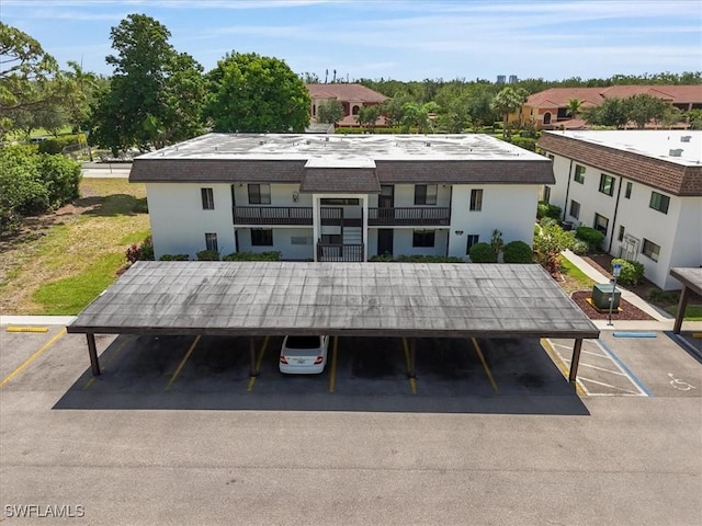 back of house featuring uncovered parking
