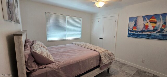 bedroom with baseboards and a ceiling fan