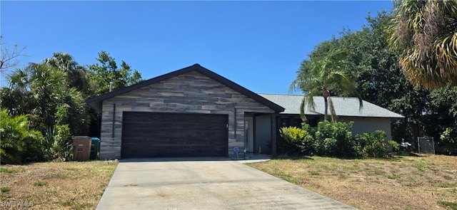 ranch-style home with driveway and an attached garage