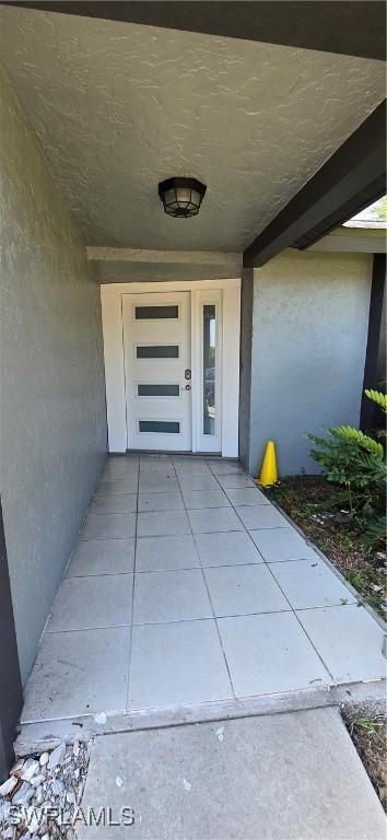 entrance to property featuring stucco siding