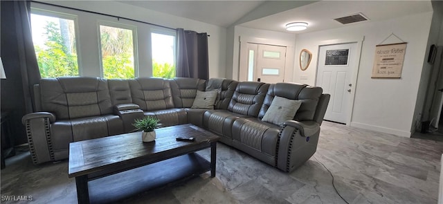 living area with lofted ceiling and baseboards