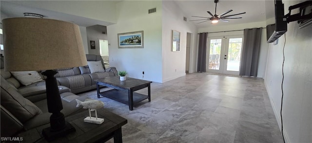 living room with baseboards, ceiling fan, french doors, and high vaulted ceiling