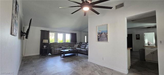 living area with a ceiling fan, baseboards, and lofted ceiling